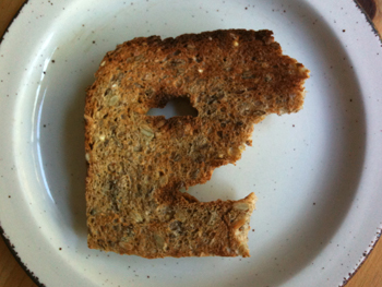 picture showing a piece of toast which looks like the profile of a face... sort of
