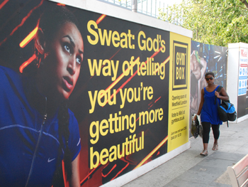 picture showing the poster for a new gym saying, sweat is god's way of telling you youre getting more beautiful